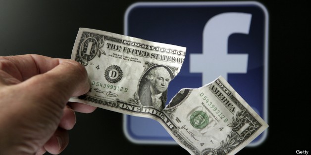GERMANY - MAY 23: Torn dollar bill in front of the Facebook logo, symbol picture: "The downward trend continues" - big losses for investors of Facebook shares. (Photo by Ulrich Baumgarten via Getty Images)